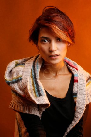 Photo for Young woman in sweater  on red background - Royalty Free Image