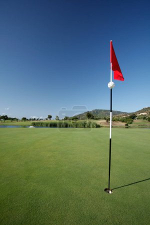 Photo for Golf course and flag on the field. - Royalty Free Image