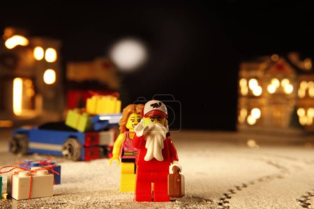 Photo for Cagliari, Italy 12 January 2011: lego figures in santa costumes  and wife on black background - Royalty Free Image