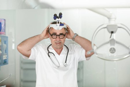 Photo for Portrait of senior doctor wearing surgical glasses - Royalty Free Image