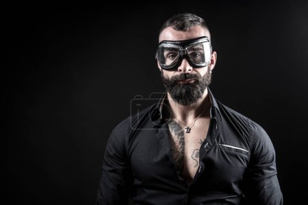 Photo for Portrait of handsome bearded man with tattoos on dark background - Royalty Free Image