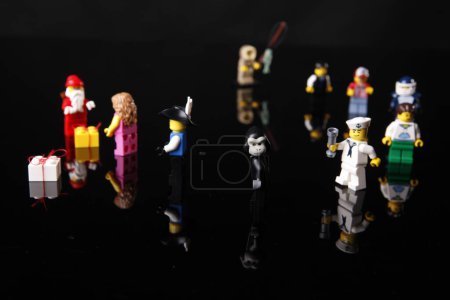 Photo for Cagliari, Italy 12 January 2011: lego figures in holiday costumes on black background - Royalty Free Image