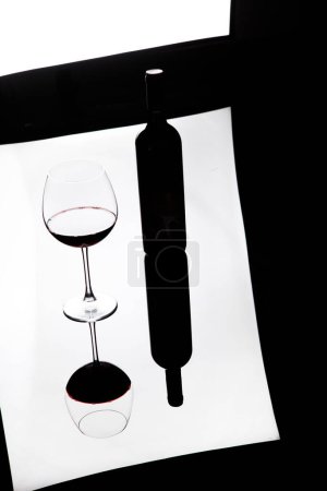 Foto de Botella de vino tinto y copa de vino sobre la mesa - Imagen libre de derechos