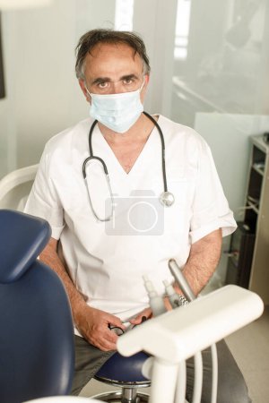 Photo for Doctor with surgical mask in white coat - Royalty Free Image