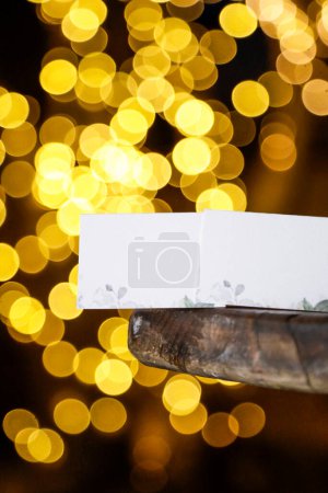Photo for Holiday background with paper cards and garland lights - Royalty Free Image