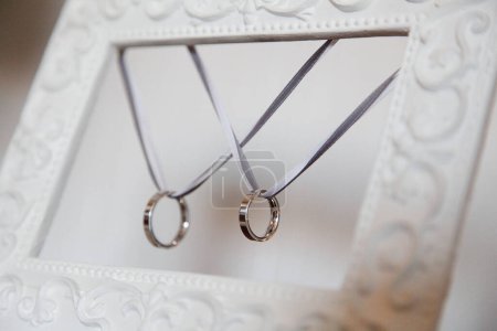 Foto de Anillos de boda y marco blanco decorativo - Imagen libre de derechos