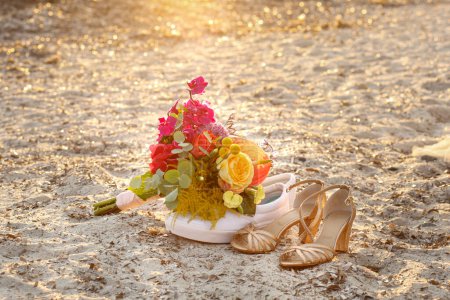 Photo for Beautiful bouquet of flowers on sandy beach - Royalty Free Image