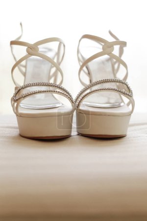Photo for Two wedding rings with a pair of shoes - Royalty Free Image