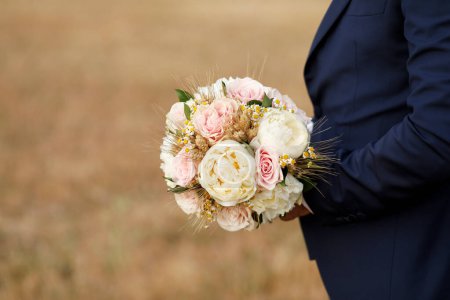 Téléchargez les photos : Marié tenant bouquet de mariage - en image libre de droit