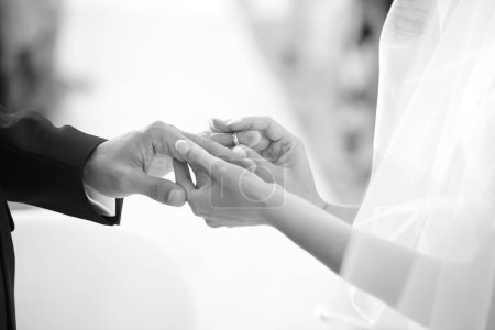 Photo for Groom puts a wedding ring in the bride hand. wedding ceremony. - Royalty Free Image