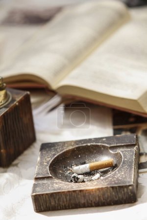 Foto de Libro viejo de la vendimia y un cigarrillo en una mesa - Imagen libre de derechos