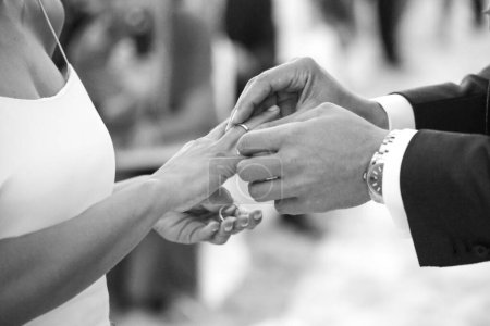 Photo for Bride and groom hold hands on wedding rings - Royalty Free Image