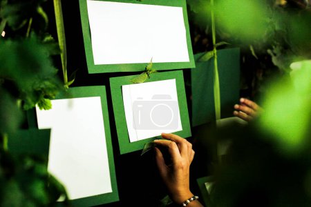 Foto de Tarjetas blancas y verdes en blanco y manos, enfoque selectivo - Imagen libre de derechos