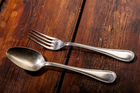 Foto de Cuchara de plata y tenedor sobre mesa de madera - Imagen libre de derechos