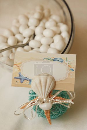 Photo for Table with delicious variegated sugared almonds elegantly displayed - Royalty Free Image