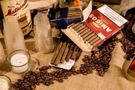 Photo for Coffee beans, candles and cigars on sackcloth - Royalty Free Image