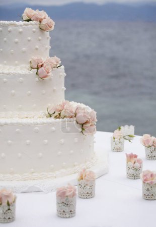 Photo for Wedding cake with roses and candles on the table. wedding cake. - Royalty Free Image