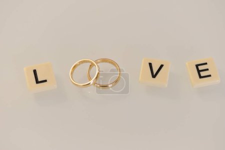 Photo for Word love and wedding rings - Royalty Free Image