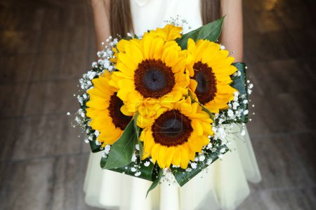 Photo for Closeup shot of girl holding a bouquet of sunflowers - Royalty Free Image