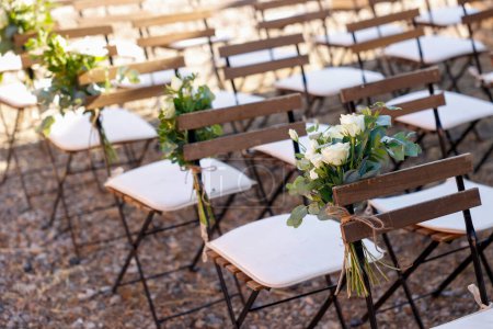 Photo for Wedding chairs with flowers on a ceremony - Royalty Free Image
