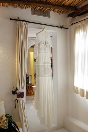 Photo for Beautiful wedding dress hanging on the hanger - Royalty Free Image