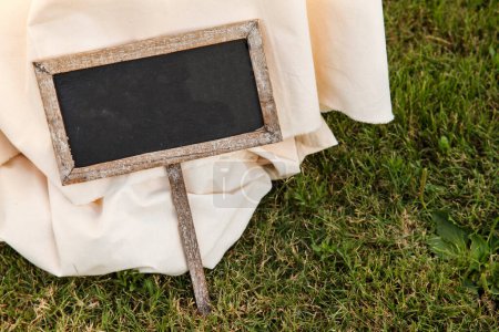 Photo for Old blackboard with space for text on the grass - Royalty Free Image