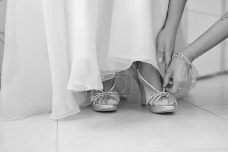 Photo for Bride in white wedding dress and shoes - Royalty Free Image