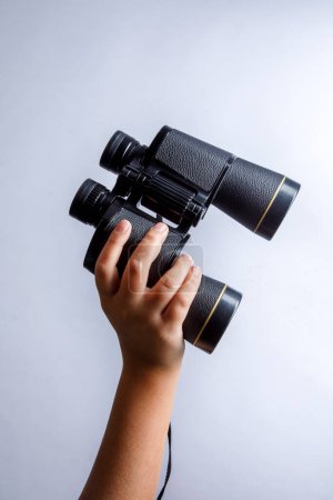 Photo for Hand holding binoculars isolated on white background. - Royalty Free Image