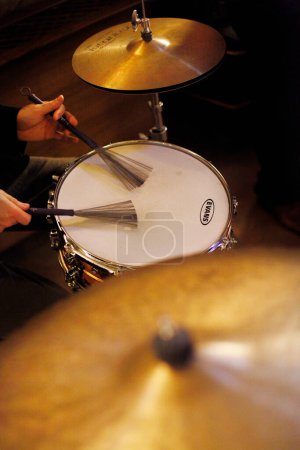 Photo for A closeup shot of a female hand playing the drum - Royalty Free Image