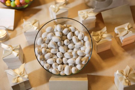 Photo for Top view of sweet white candies and small gift boxes on table - Royalty Free Image