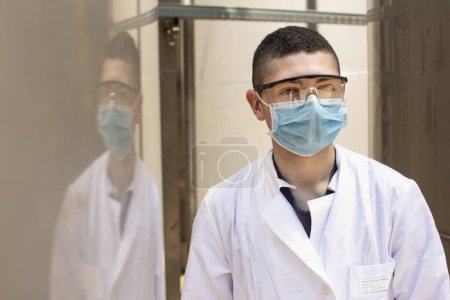 Photo for Scientist looking at camera in laboratory - Royalty Free Image