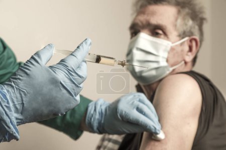 Photo for Doctor vaccinating patient in hospital clinic - Royalty Free Image