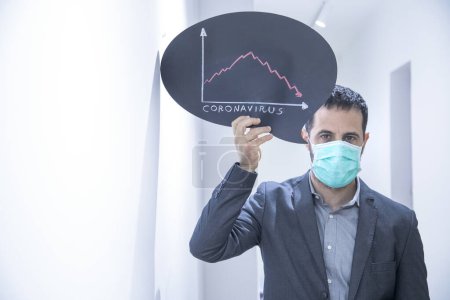 Photo for Dark-haired man in a suit with an antivirus mask, shows a sign against the data of the Crown virus infection - Royalty Free Image