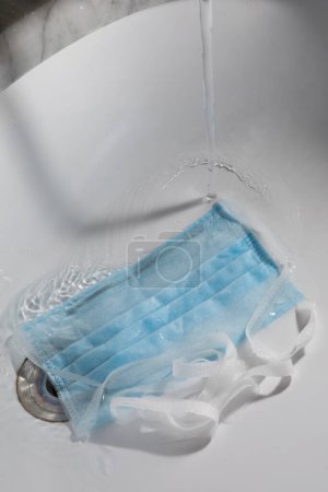 Photo for Washing with detergent of a surgical mask - Royalty Free Image