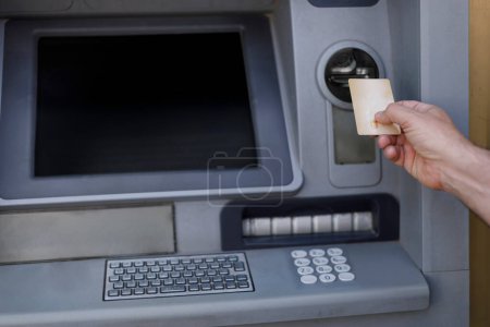 Photo for Detail of the cash withdrawal from an ATM with a credit card - Royalty Free Image