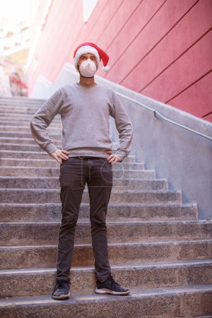 Photo for Young man wearing protective hat and face mask descends into the underpass - Royalty Free Image