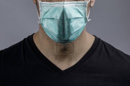 Téléchargez les photos : Homme visage porter masque protecteur isolé sur fond noir - en image libre de droit