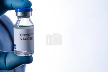 Photo for Coronavirus vaccine bottle in the background - Royalty Free Image