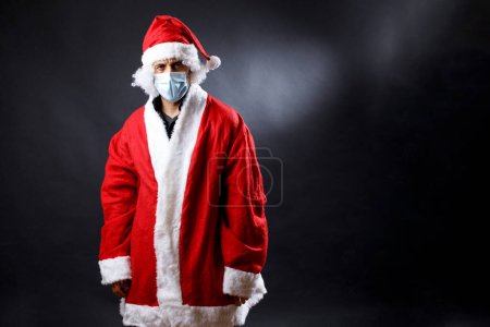 Photo for Portrait of santa claus looking serious and worried, isolated over black background - Royalty Free Image