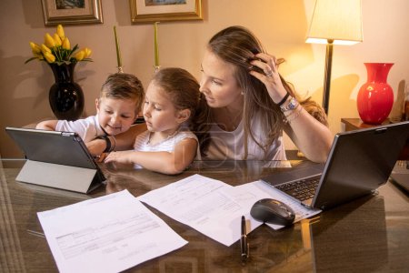 Photo for Mom with kids doing homework - Royalty Free Image