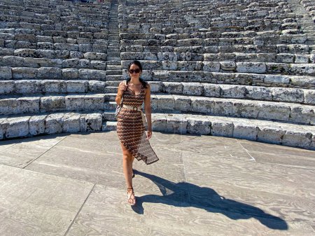 Photo for Woman in dress walking in ancient ruins - Royalty Free Image