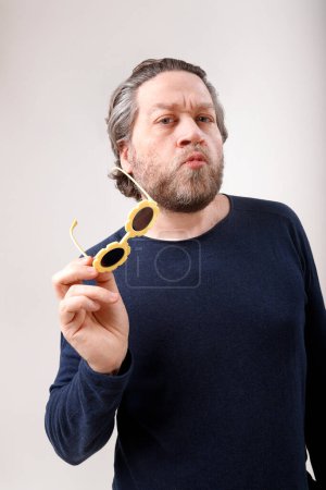 man with grimace and funny sunglasses on studio