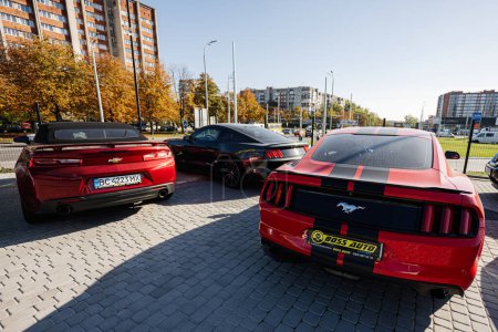 Photo for Lviv, Ukraine - October 09, 2022: Chevrolet Camaro and Ford Mustang, american muscle cars on car  market. - Royalty Free Image