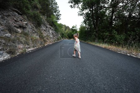 Foto de Baby girl run in mountain road of Nocera Umbra,  town and comune in the province of Perugia, Italy. - Imagen libre de derechos