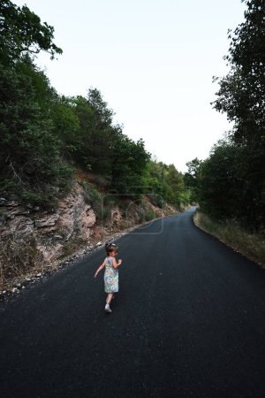 Foto de Baby girl run in mountain road of Nocera Umbra,  town and comune in the province of Perugia, Italy. - Imagen libre de derechos
