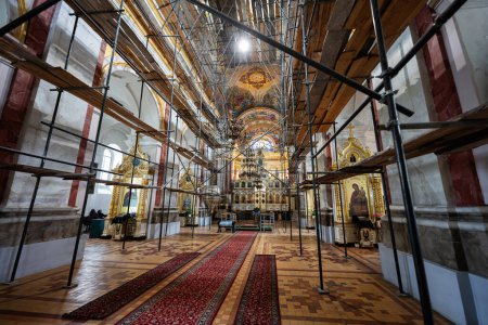 Photo for Lutsk, Ukraine - March, 2024: Inside view of a Holy Trinity Orthodox Cathedral undergoing renovation, featuring scaffolding and ornate decoration amidst construction. - Royalty Free Image