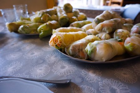 Photo for Plate of Chinese spring rolls, a typical dish cooked in Southeast Asia comprising a pancake wrapped in a rice flour dough filled with vegetables such as green salad, meat or shrimps and noddles - Royalty Free Image