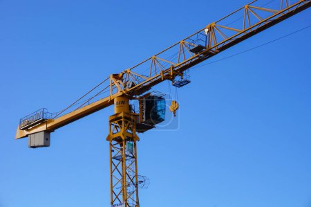 Photo for Troyes, France - Sept. 2020 - A yellow construction crane manufactured by Potain, a French branch of the US group Manitowoc and the world leader in tower crane - Royalty Free Image