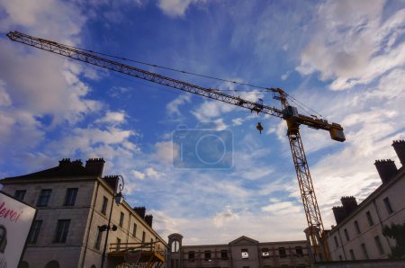 Photo for Troyes, France - Sept. 2020 - A tower crane dominates the demolition site of the former Gendarmerie (police) barracks, aimed to be turned into the luxury hotel La Licorne after rehabilitation works - Royalty Free Image