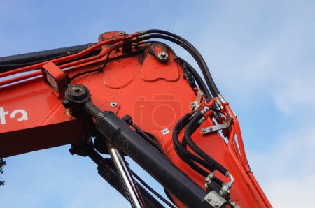 Photo for Tarn, France - Dec. 2020 - Mechanical joint of a boom actuated by hydraulic cylinders, themselves powered with hoses, on anexcavator from the Japanese manufacturer of construction equipment Kubota - Royalty Free Image